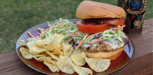 wild turkey burger on plate with slaw and chips
