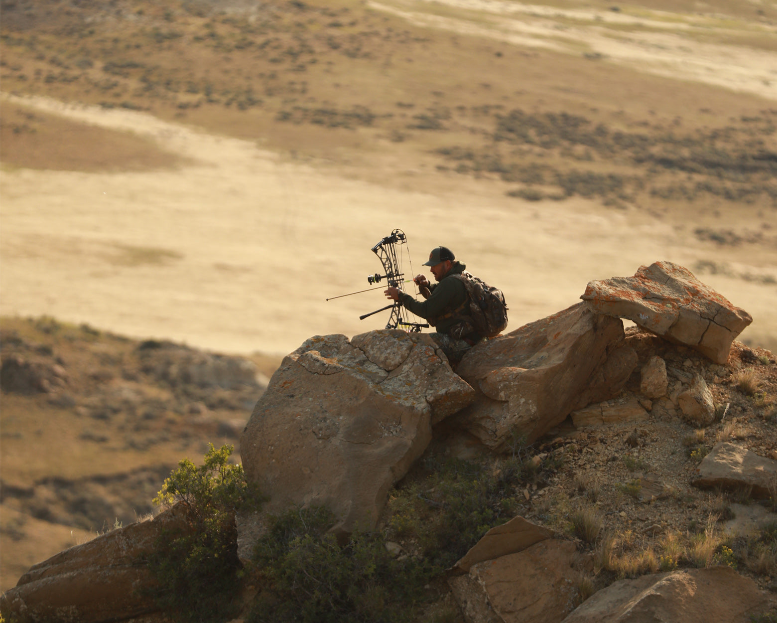 gamehide archery hunter on top of rock point