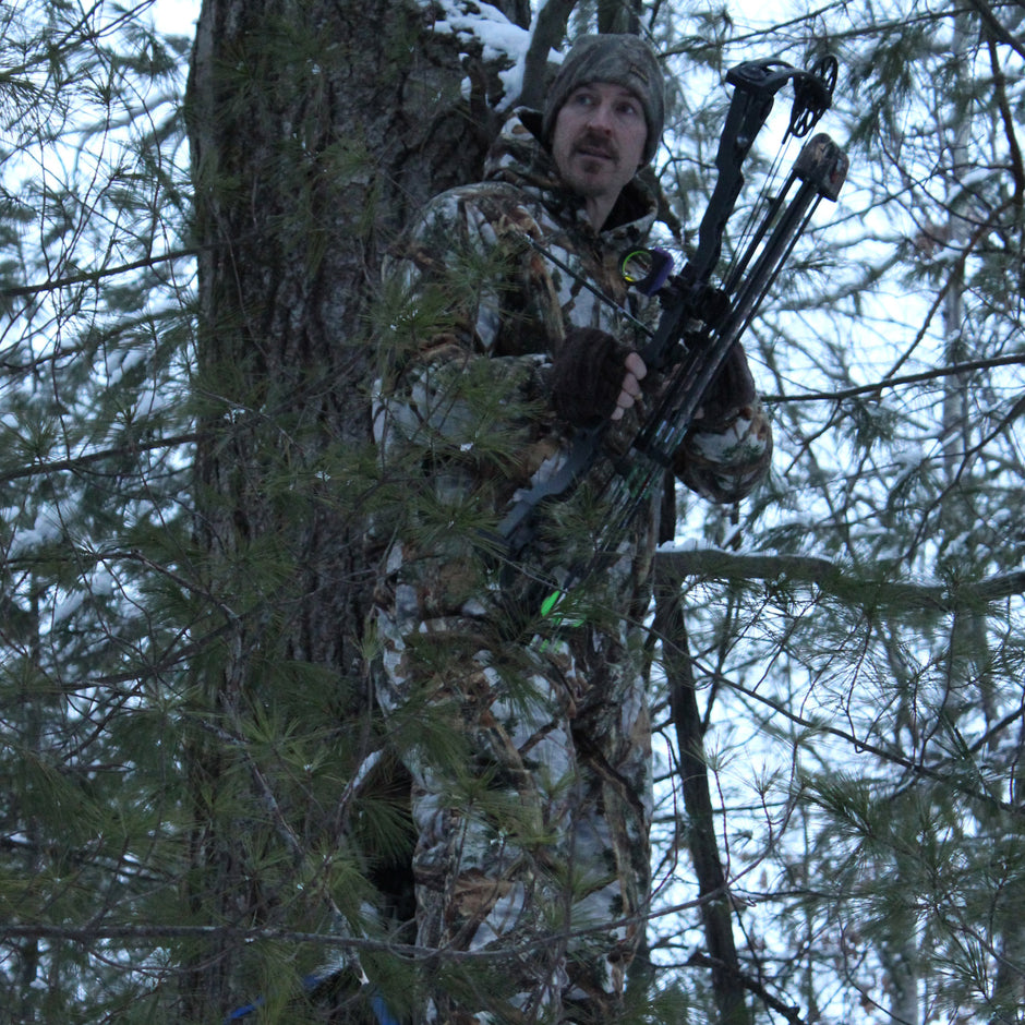 archery hunter in treestand wearing woodlot camo