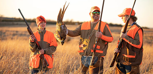 three gamehide upland vest wearing hunters in field