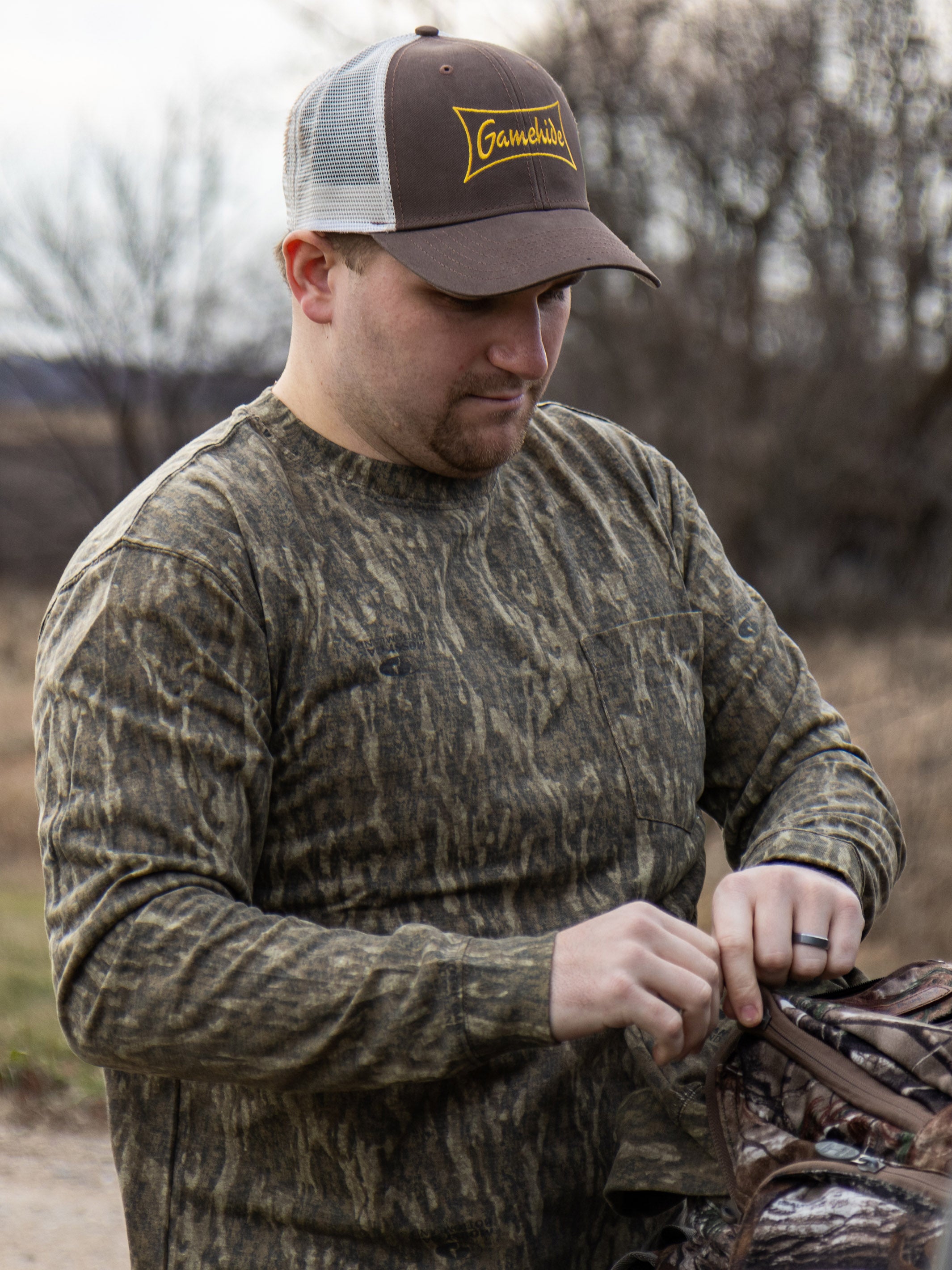 man wearing gamehide logo hat