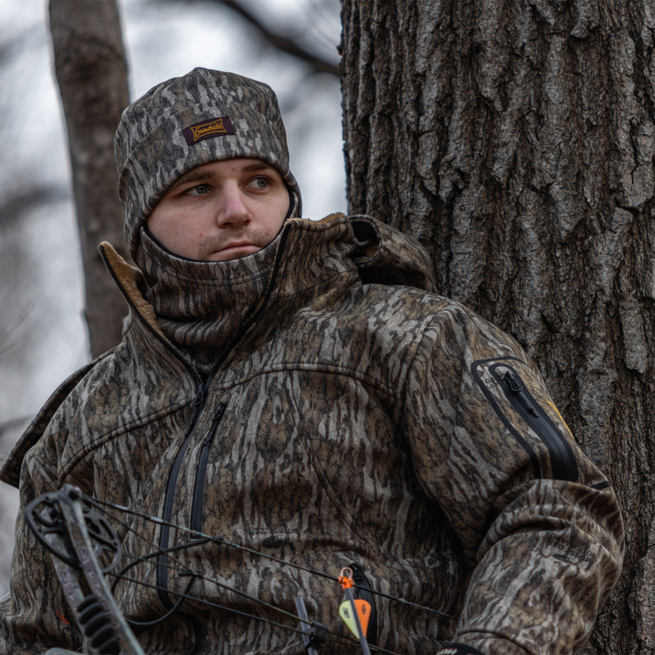 bowhunter in tree wearing new bottomland camo insulated