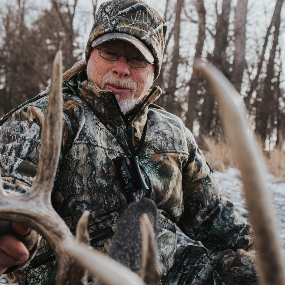 hunter with antler wearing realtree camo