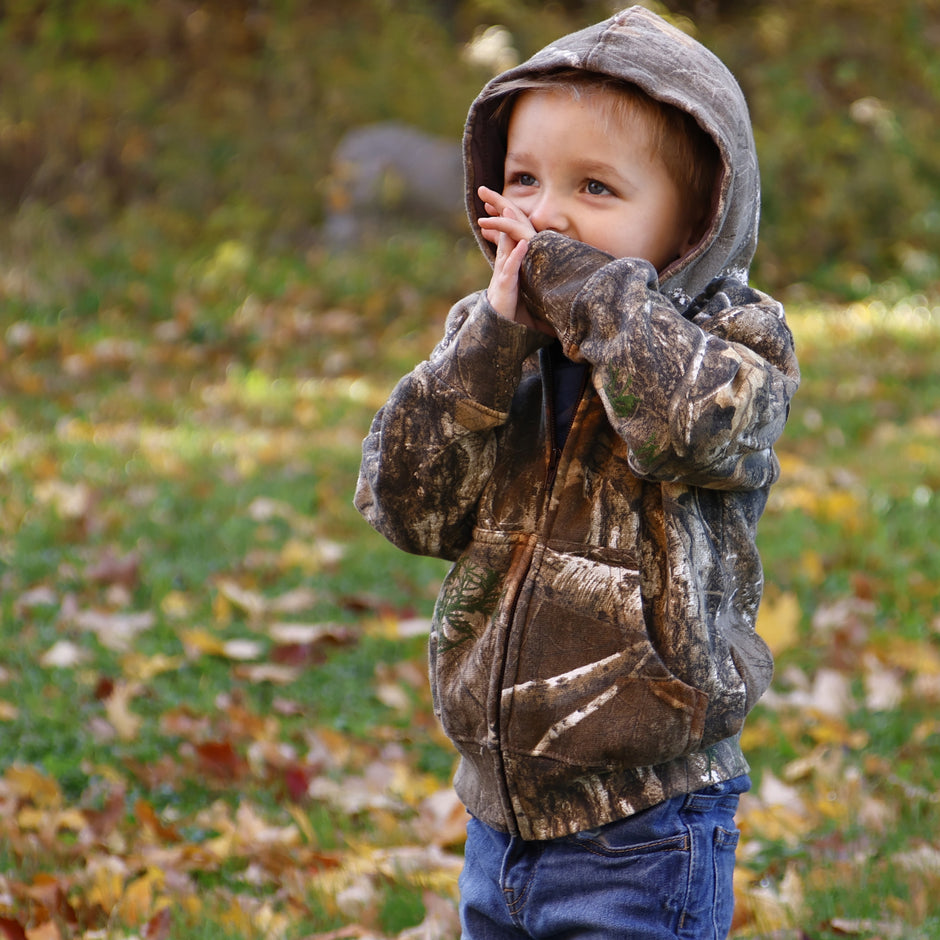toddler wearing camo hoodie and jeans